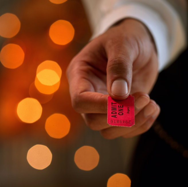 Hand holding ticket